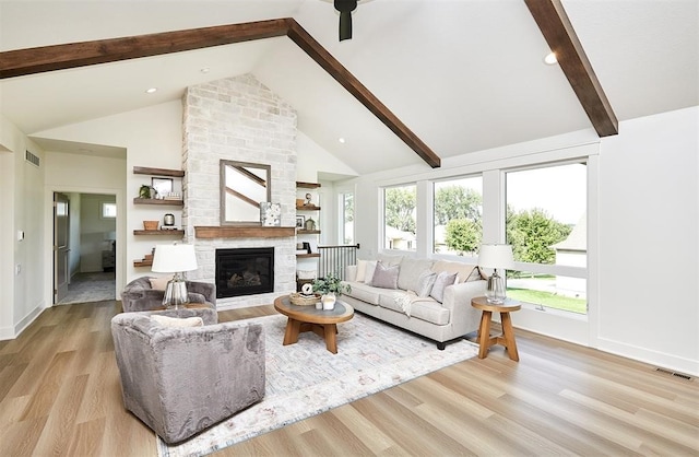 4925 162nd St, Urbandale, IA 50323 - living area with beamed ceiling, high vaulted ceiling, a stone fireplace, wood finished floors, and baseboards