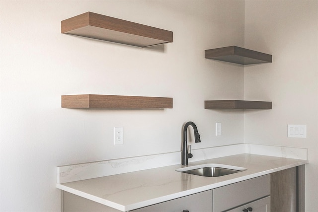 kitchen with sink and light stone countertops