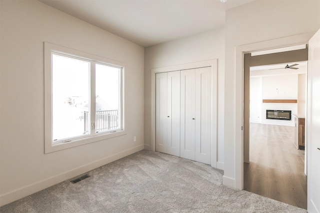 unfurnished bedroom featuring carpet flooring and a closet