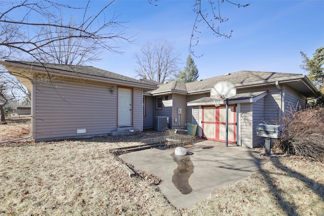 view of front of home with a storage shed, a patio area, and central air condition unit