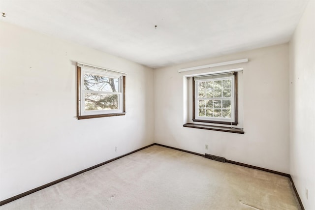 unfurnished room with light carpet