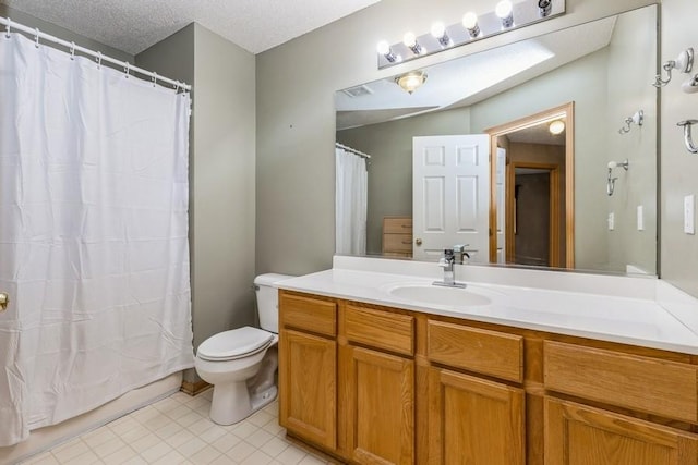 bathroom featuring a shower with curtain, vanity, toilet, and a textured ceiling