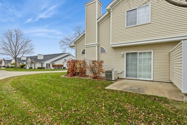 exterior space featuring a lawn, a patio, and central air condition unit