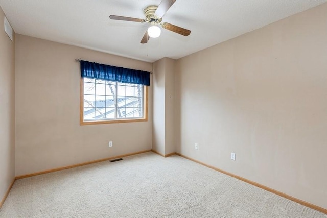 unfurnished room with ceiling fan and carpet flooring