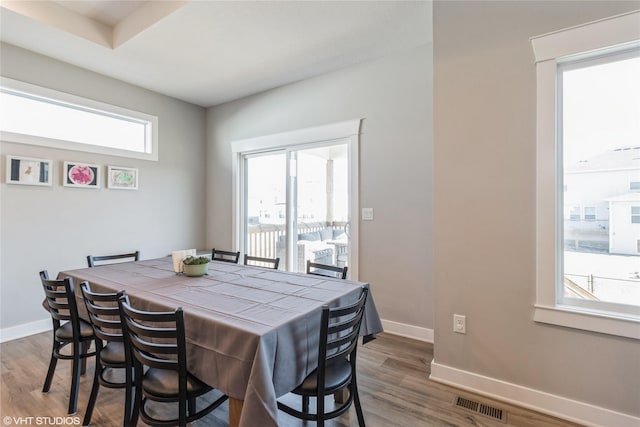 dining area with dark hardwood / wood-style flooring