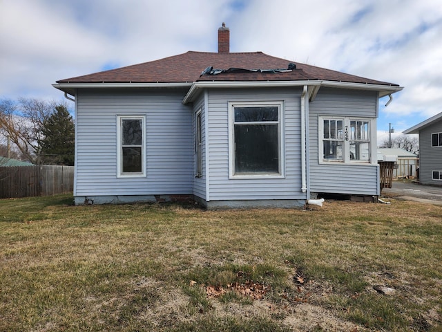 back of house featuring a yard