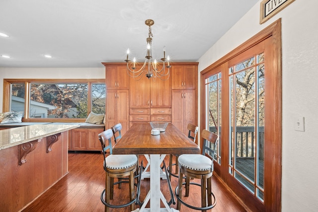 dining room with a notable chandelier and dark wood-type flooring