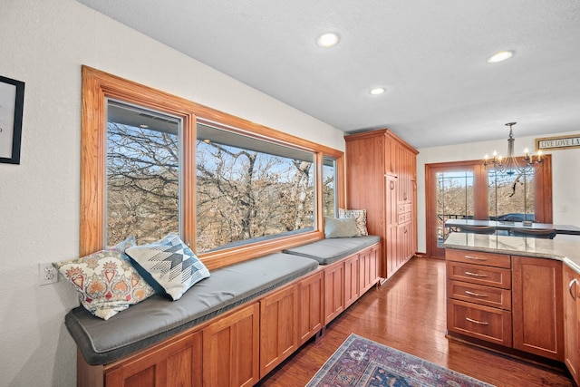 kitchen with dark wood-type flooring, decorative light fixtures, and a chandelier