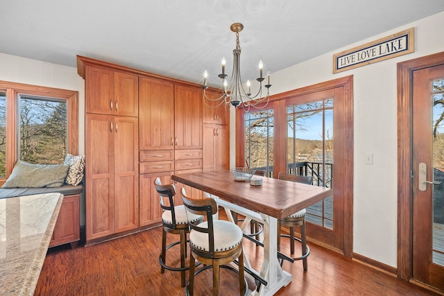 dining room with an inviting chandelier and dark hardwood / wood-style floors