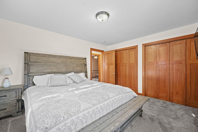 bedroom with two closets and carpet floors