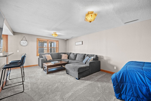 carpeted living room featuring a textured ceiling