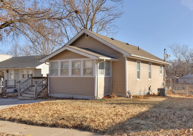 view of front of property with central AC and fence