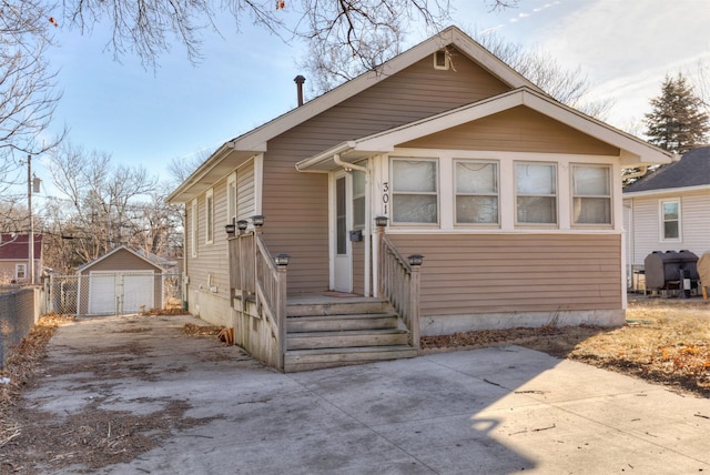 bungalow-style home with an outbuilding and a garage