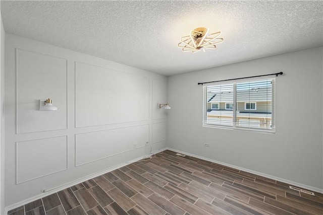 empty room featuring a textured ceiling