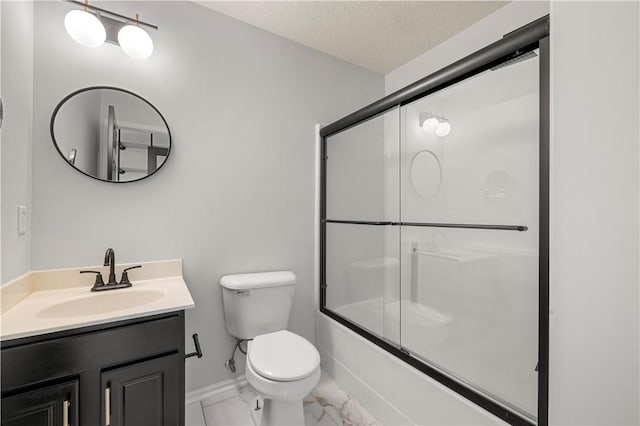 full bathroom featuring vanity, a textured ceiling, shower / bath combination with glass door, and toilet