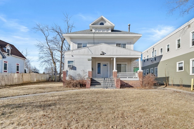 view of front of property featuring covered porch and a front lawn