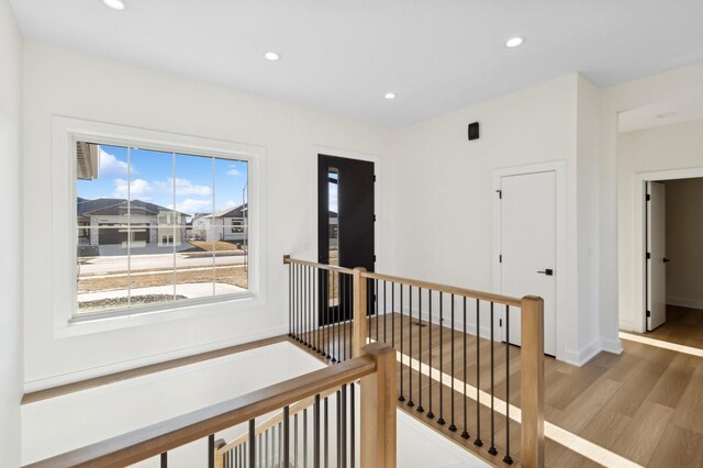 hallway with hardwood / wood-style floors