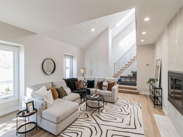 living room featuring vaulted ceiling and light hardwood / wood-style flooring