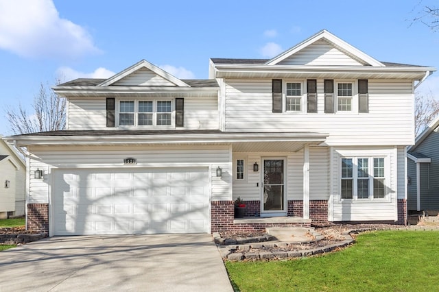 view of front of home featuring a garage, a front yard, and covered porch