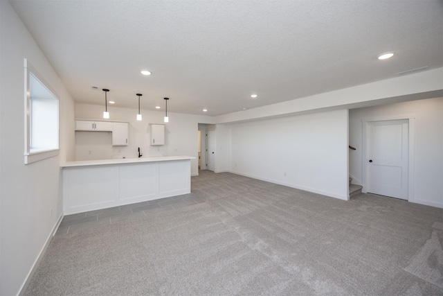 unfurnished living room with light carpet, baseboards, and recessed lighting