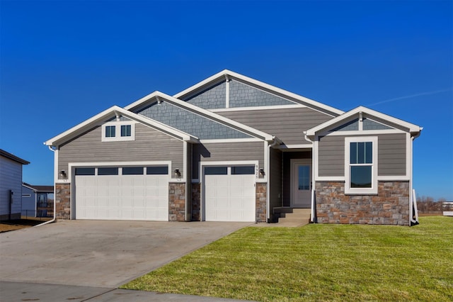 craftsman-style home with a garage, a front lawn, and concrete driveway