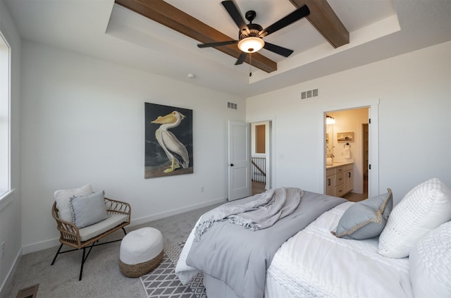 carpeted bedroom with ceiling fan, connected bathroom, and a tray ceiling