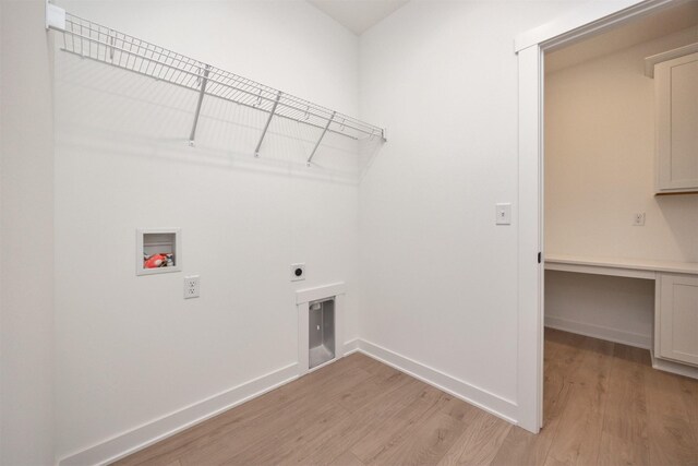 laundry room with electric dryer hookup, hookup for a washing machine, and light hardwood / wood-style flooring