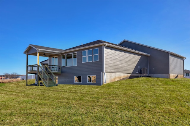 view of property exterior featuring central AC, a lawn, a deck, and stairs