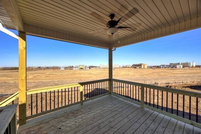 wooden terrace featuring a rural view and ceiling fan