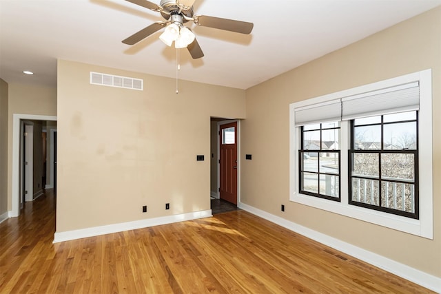 unfurnished room with hardwood / wood-style flooring and ceiling fan