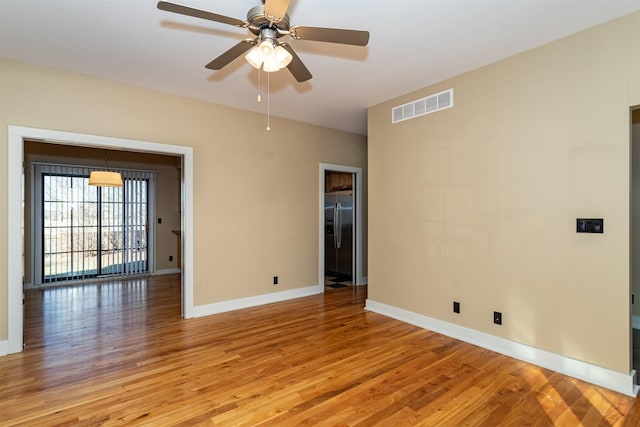 empty room with light hardwood / wood-style floors and ceiling fan