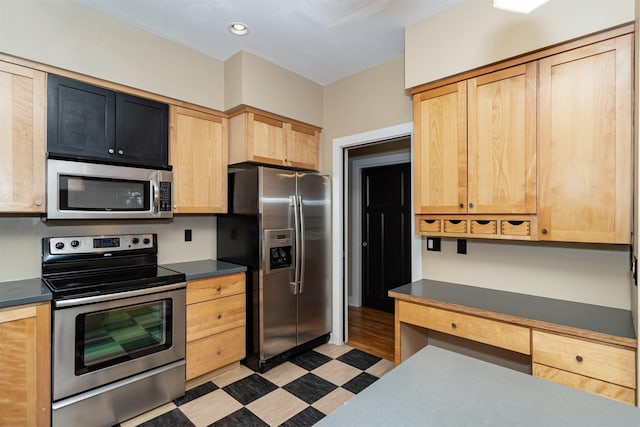 kitchen with light brown cabinetry and stainless steel appliances