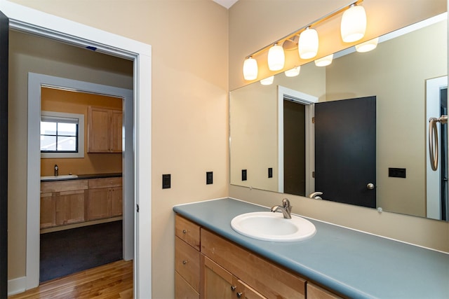 bathroom featuring hardwood / wood-style flooring and vanity