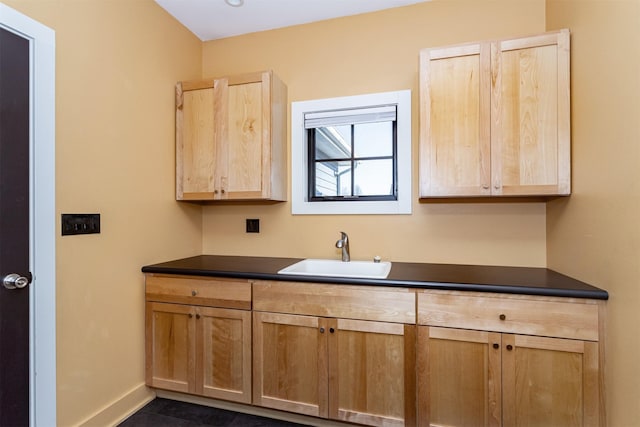 kitchen with sink and dark tile patterned floors