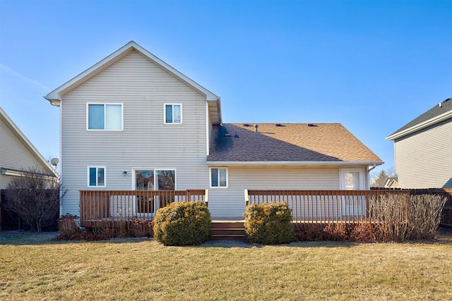 rear view of property with a yard and a deck