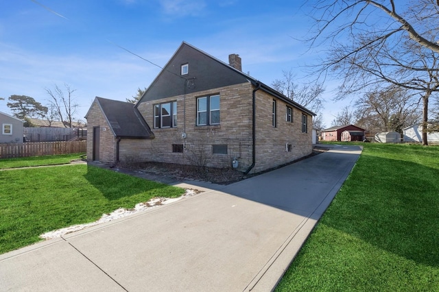 view of side of home with a yard