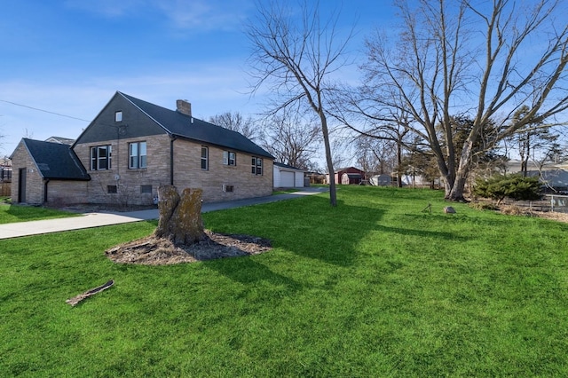 view of side of property with a garage and a lawn