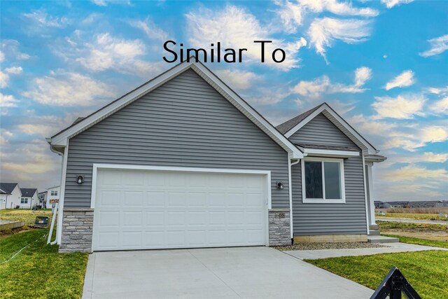 view of front of house with a garage and a front lawn