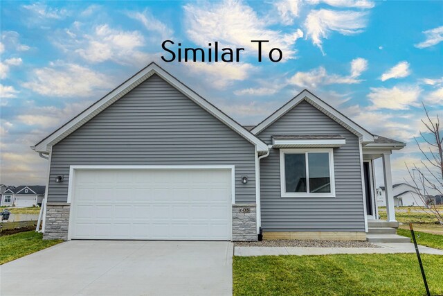 ranch-style house with a garage and a front yard