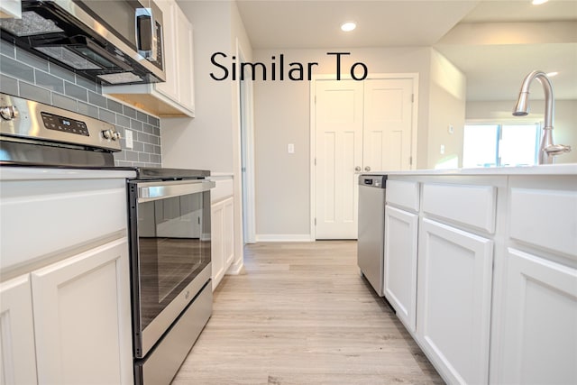 kitchen featuring backsplash, stainless steel appliances, white cabinets, and light wood-type flooring