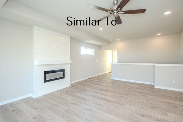 unfurnished living room with ceiling fan, a fireplace, and light wood-type flooring