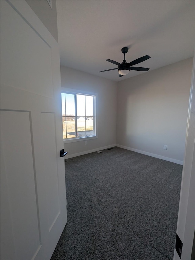 carpeted spare room featuring ceiling fan