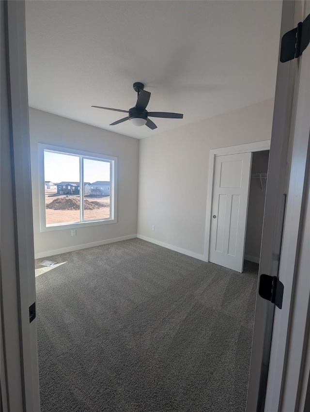 spare room with carpet floors and ceiling fan