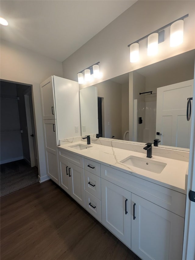 bathroom featuring vanity, hardwood / wood-style floors, and a shower