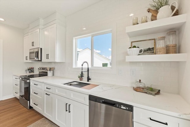 1902 16th Cir SE, Altoona, IA 50009 - kitchen with stainless steel appliances, open shelves, tasteful backsplash, and white cabinetry