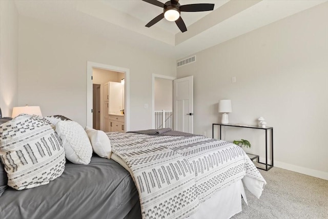1902 16th Cir SE, Altoona, IA 50009 - bedroom featuring carpet, ensuite bathroom, ceiling fan, and a raised ceiling