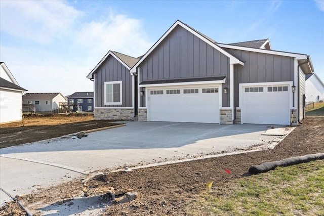 1902 16th Cir SE, Altoona, IA 50009 - modern inspired farmhouse featuring board and batten siding, an attached garage, stone siding, and concrete driveway