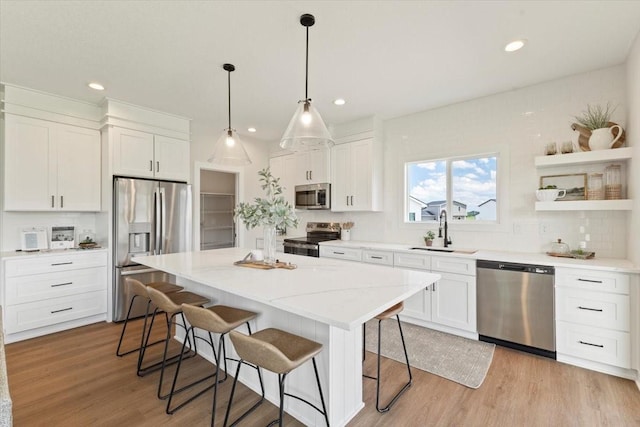 1902 16th Cir SE, Altoona, IA 50009 - kitchen featuring appliances with stainless steel finishes, a breakfast bar area, a kitchen island, white cabinetry, and recessed lighting