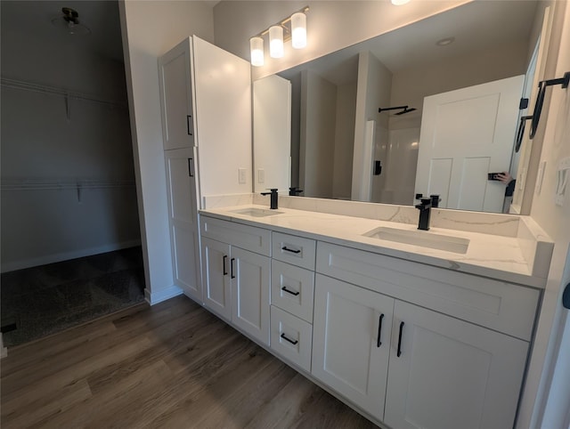 bathroom with vanity, hardwood / wood-style floors, and a shower