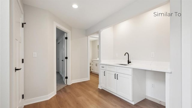 interior space with sink and light wood-type flooring